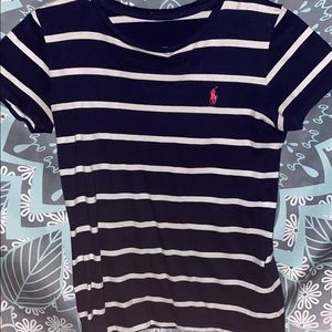 Navy blue and white polo shirt .